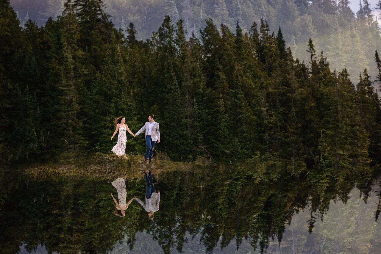 couple walking on sand dune in the pines on Lake Michigan in frankfort