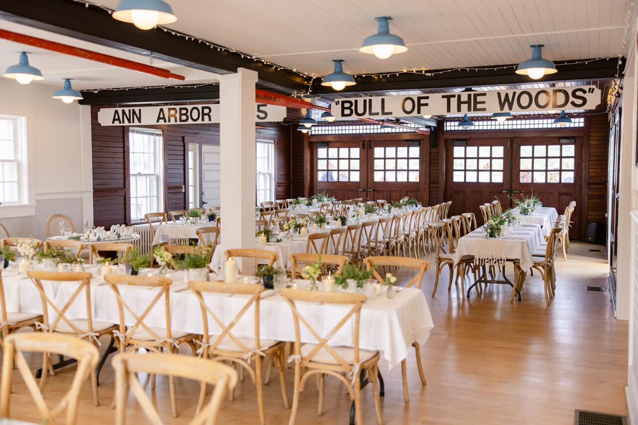 white farm tables with simple beautiful candles and green plants