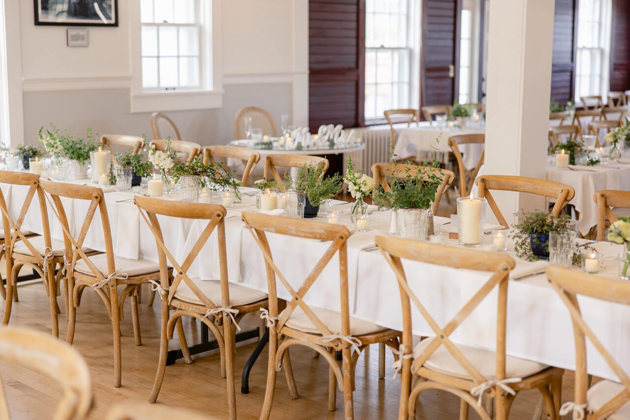 white farm tables with simple beautiful candles and green plants