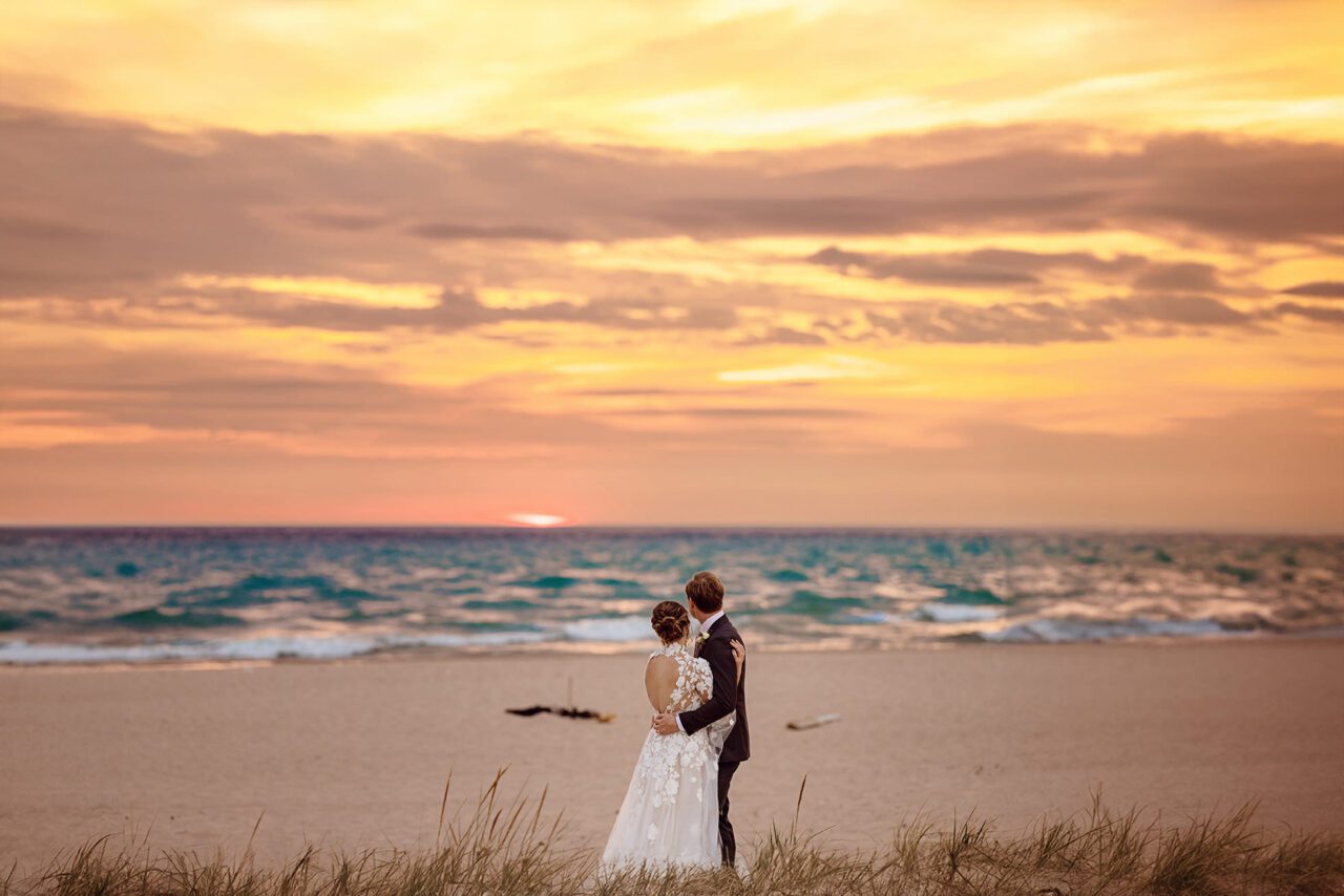 Wedding Couple on Lake Michigan beach at sunset after wedding