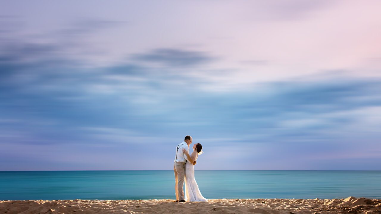 Bride and Groom on Lake Michigan at sunset at Elberta Life Saving Station