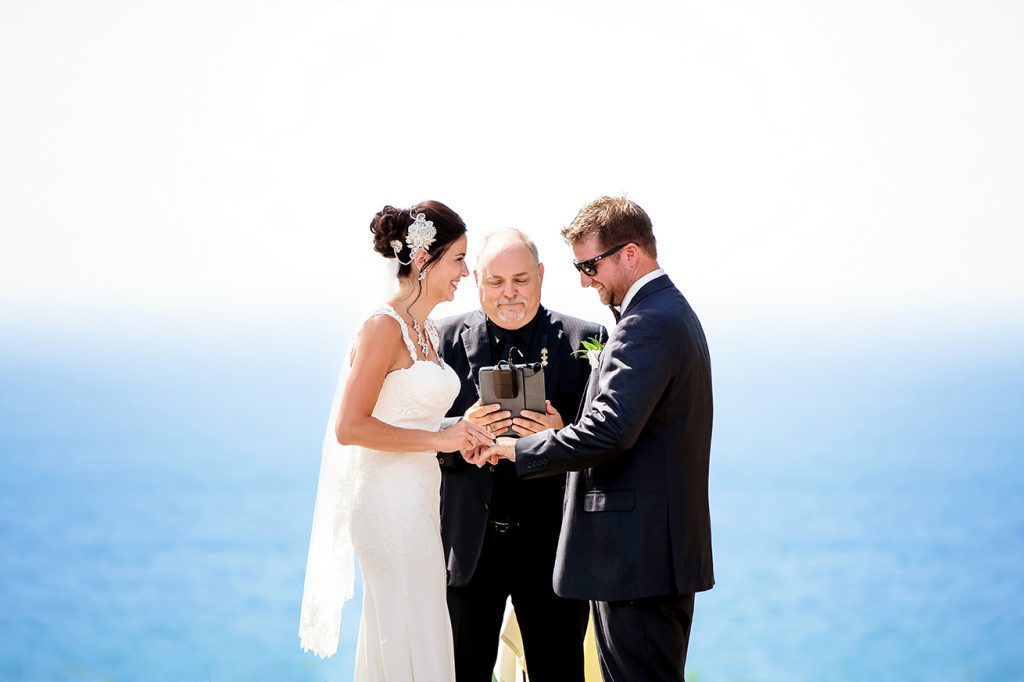 bride and groom exchanging rings overlooking lake michigan